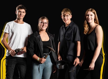 Vier junge Menschen mit unterschiedlicher Berufskleidung und Geräten vor schwarzem Hintergrund.